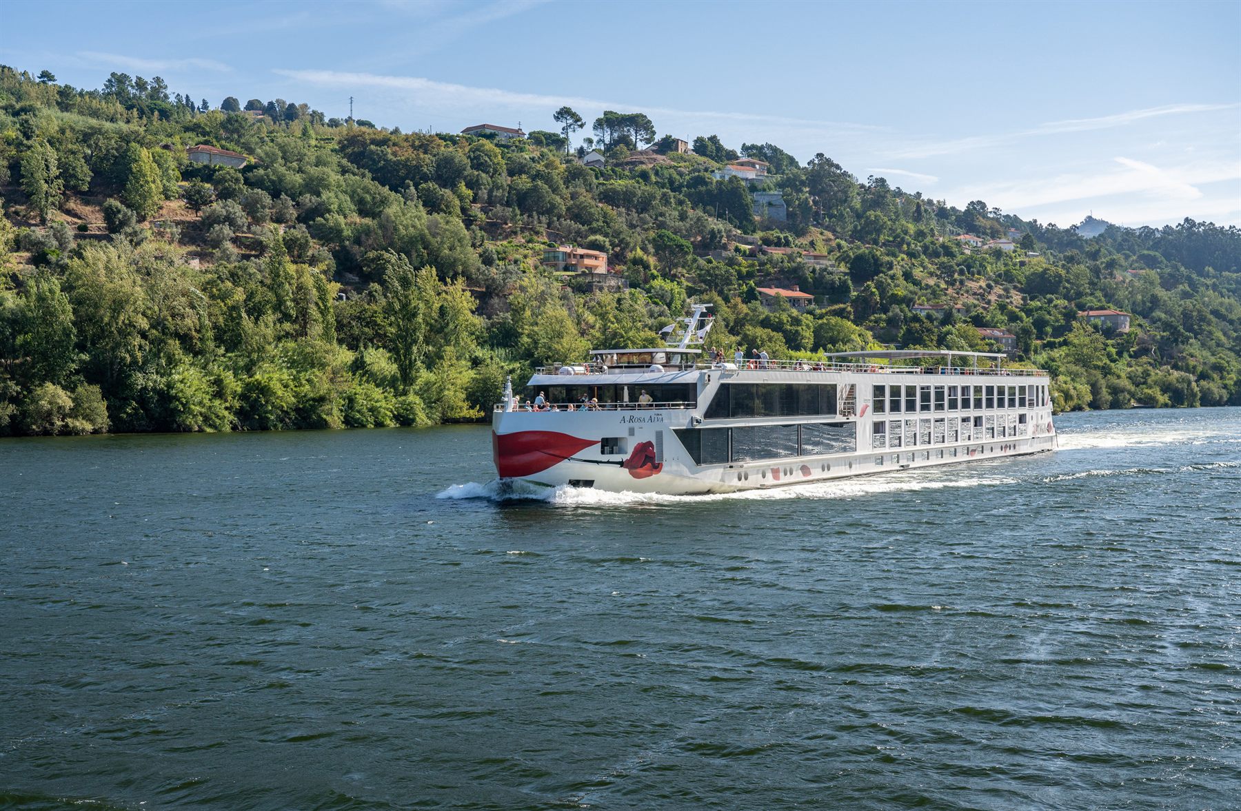 River cruise ship on the Douro between wooded hills