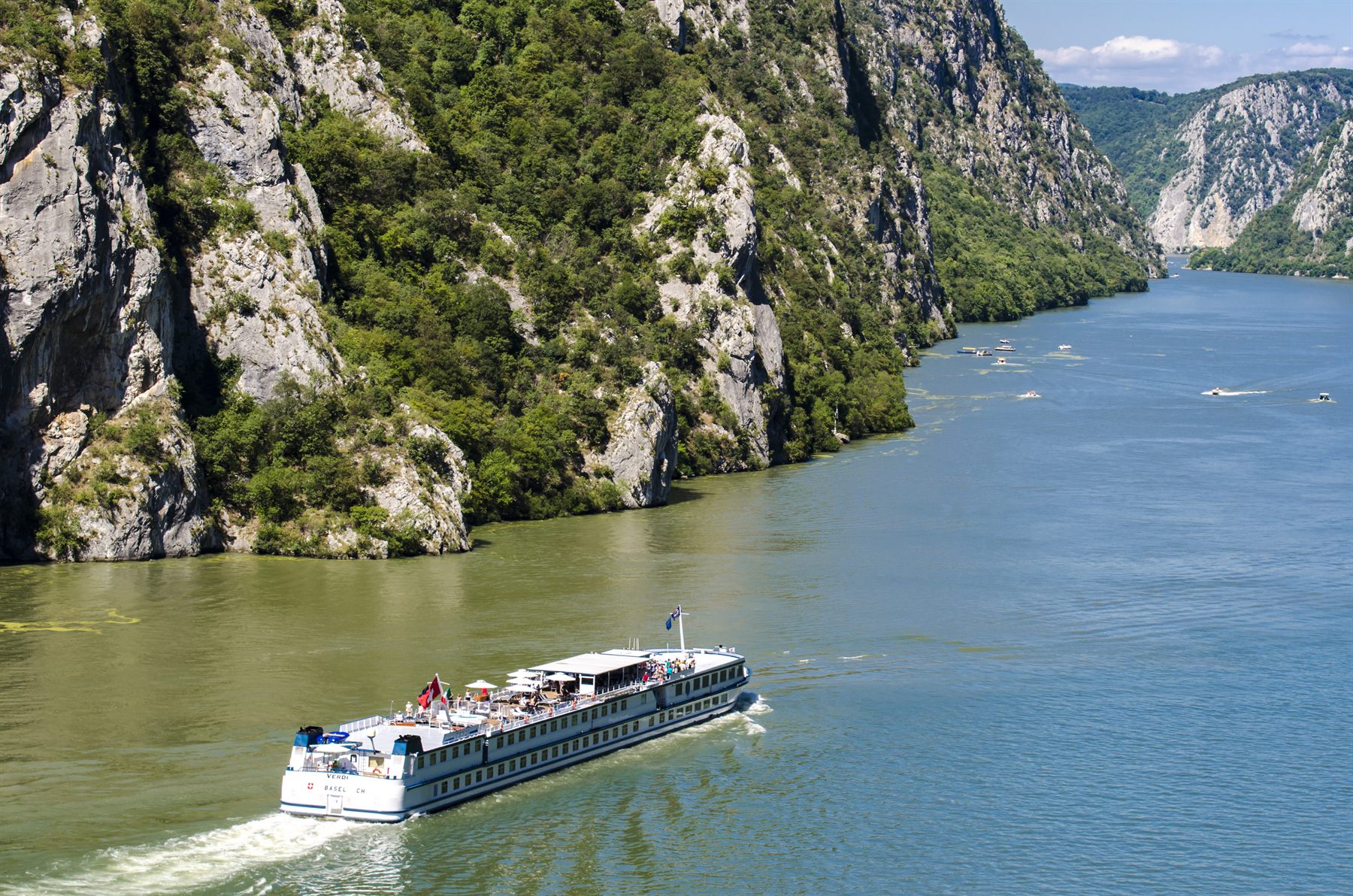 River cruise ship sailing through a steep limestone gorge